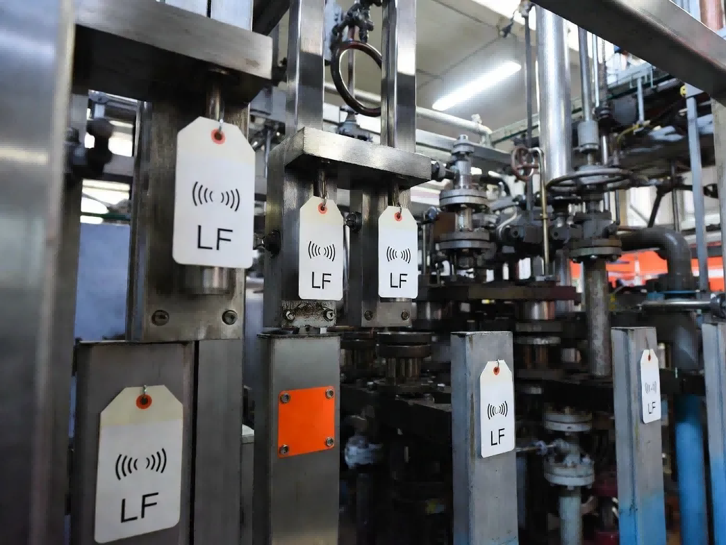 Industrial manufacturing environment demonstrating LF long range RFID tags deployed in metal-heavy stamping lines and fluid-exposed livestock gates where UHF signals fail